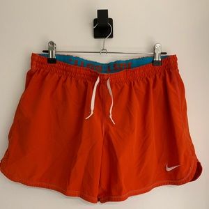 NIKE Dri-fit shorts. Red with blue built in spandex. Size M.